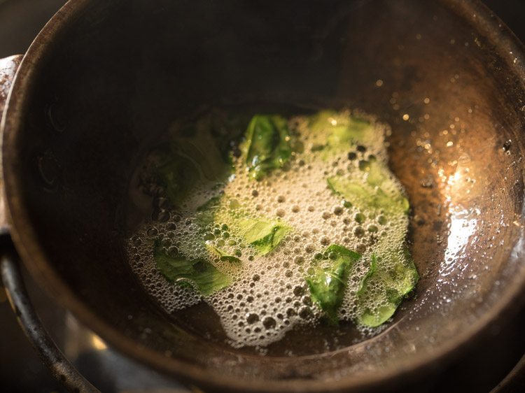 curry leaves and asafoetida added to hot sesame oil. 