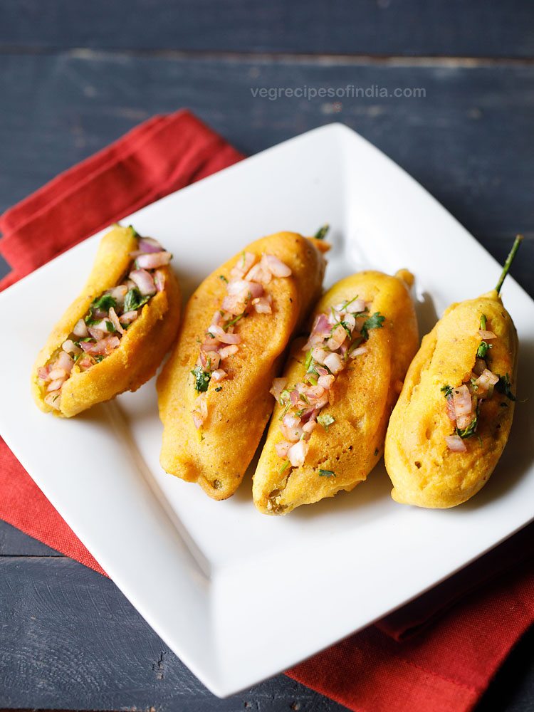 mirchi bajji or chilli bajji served in a square white plate with text layover. 