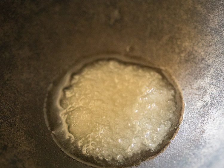 heating coconut oil in a pan for making vazhakkai fry. 