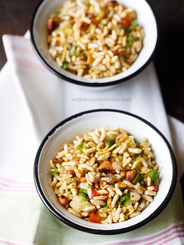 jhal muri served in a black rimmed bowl. 