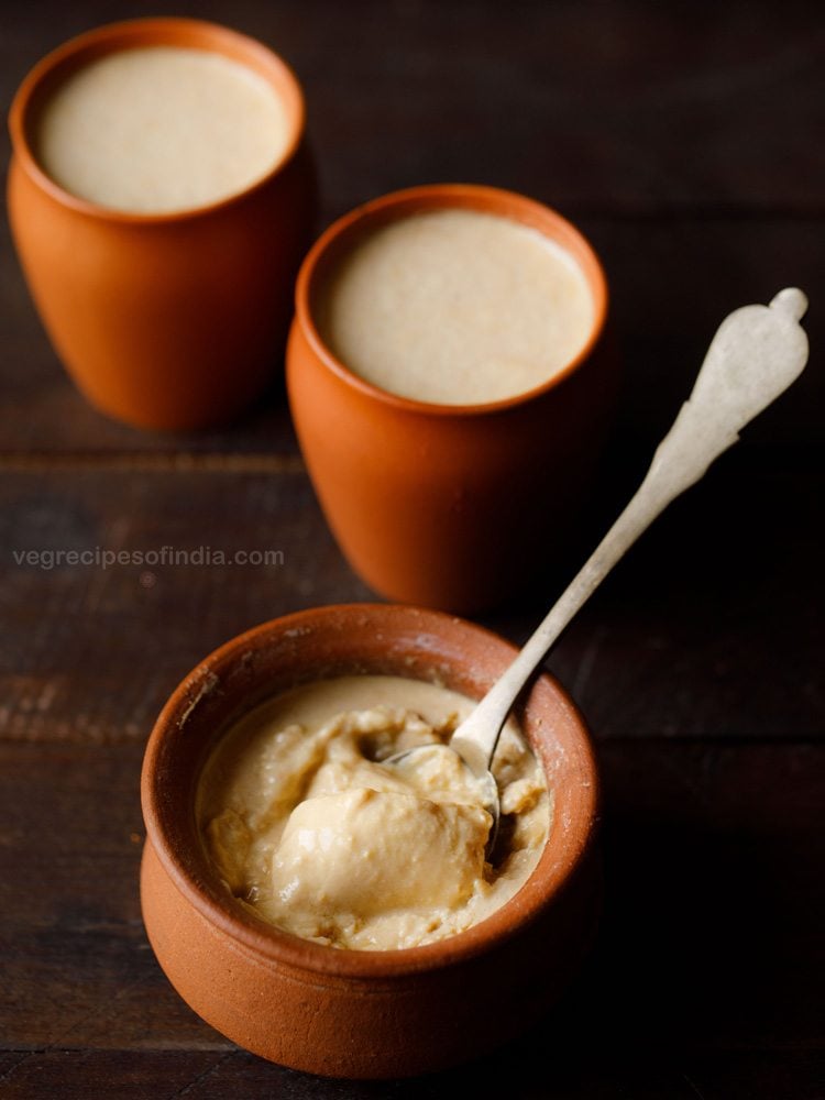 mishti doi served in an earthen bowl with a spoon in it and text layover. 