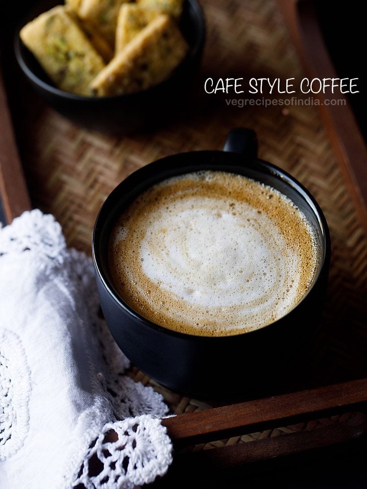 hot cafe-style coffee on a wooden tray with a white lace doily.