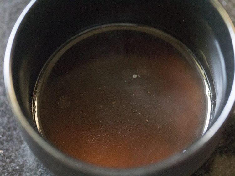 adding hot water to sugar and instant coffee.