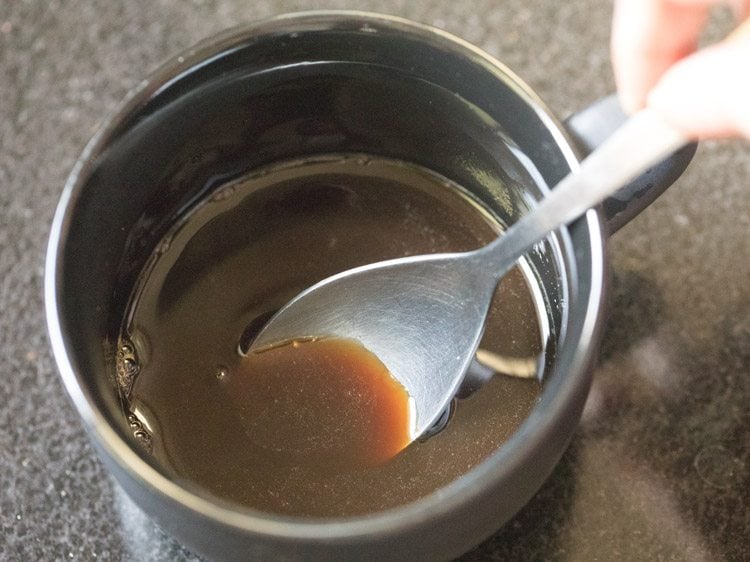 stirring instant coffee with hot water.