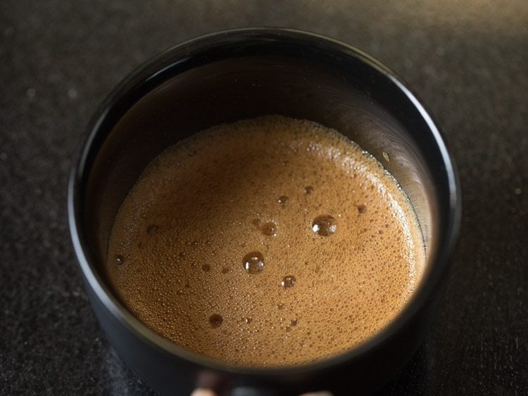 instant coffee mixture is still foamy.