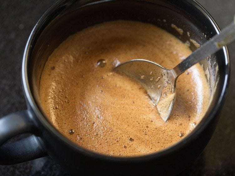 stirring the beaten coffee with some of the milk.