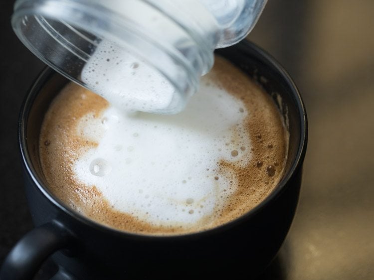 pouring out the last of the milky foam for a nice cappuccino style coffee at home.