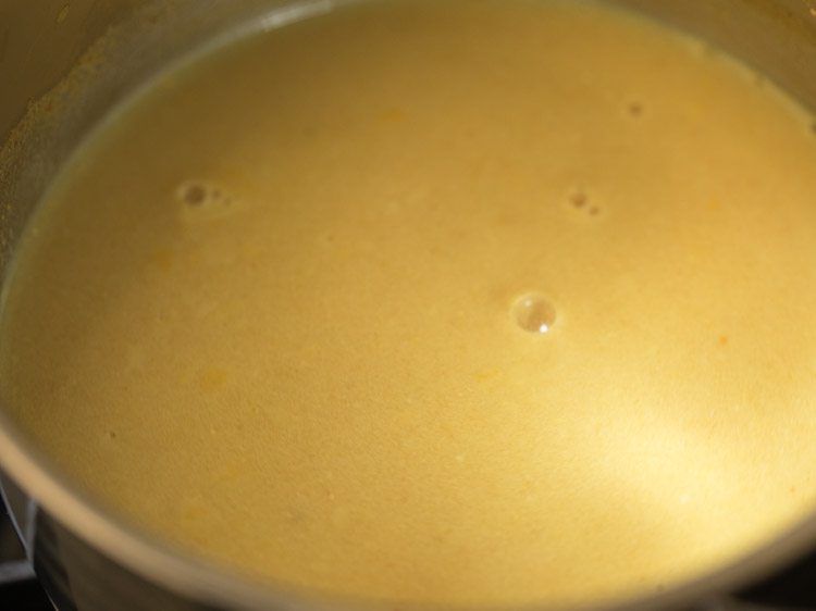 coconut milk mixed well in tamarind mixture for thengai paal rasam. 