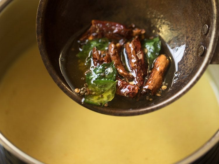 adding tempering to prepared thengai paal rasam. 