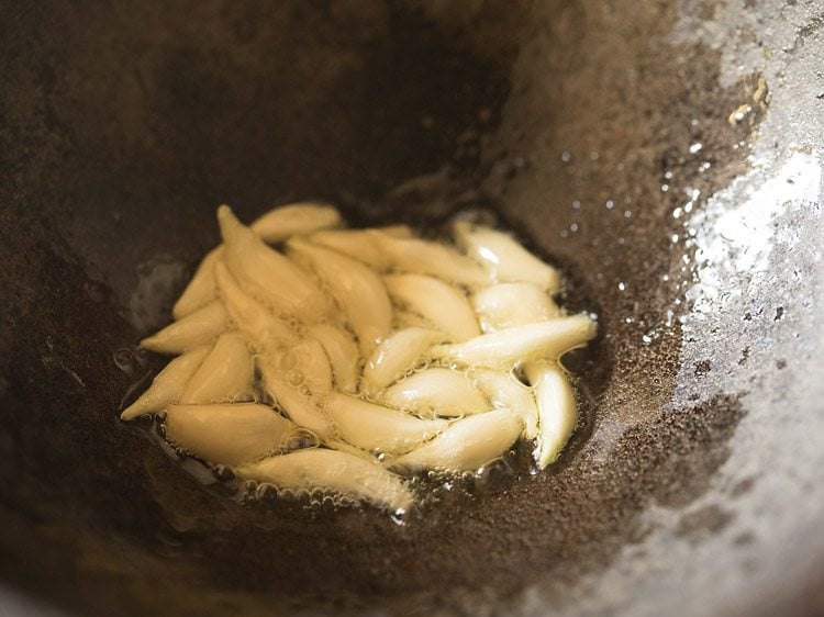 sautéing garlic cloves for making dry garlic chutney recipe.