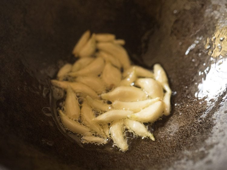 garlic is still cooking for making lasun khobra chutney recipe.