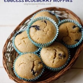 vegan blueberry muffins in a bamboo tray with text layovers.