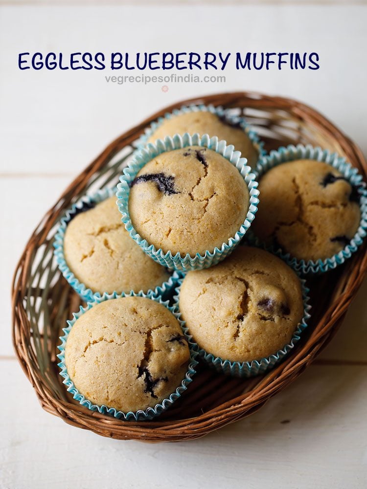 vegan blueberry muffins in a bamboo tray with text layovers.