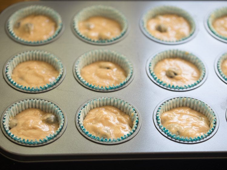 muffin batter added to muffin moulds