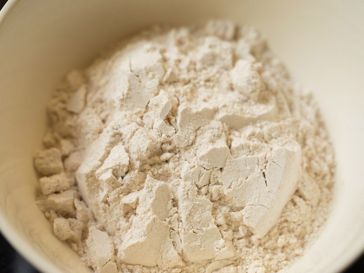 Close up shot of whole wheat flour in mixing bowl.