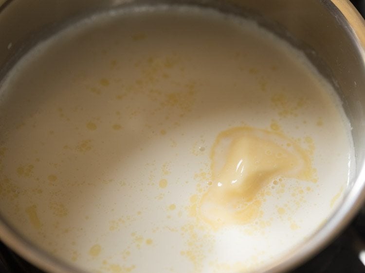 Closeup shot of milk and butter in saucepan.