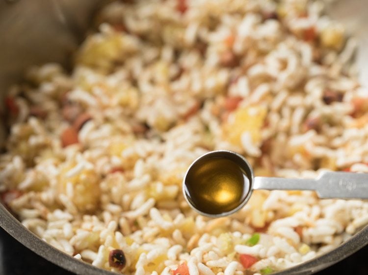 adding mustard oil to the puffed rice mixture. 