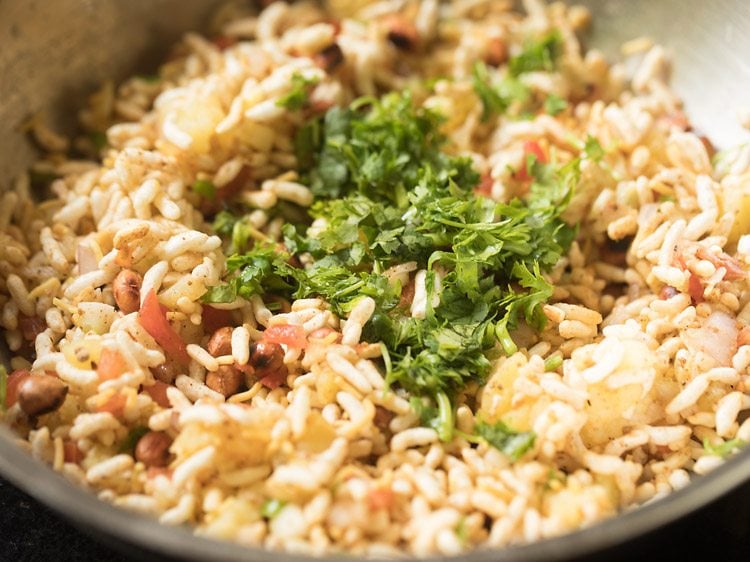 chopped coriander leaves added to jhal muri. 