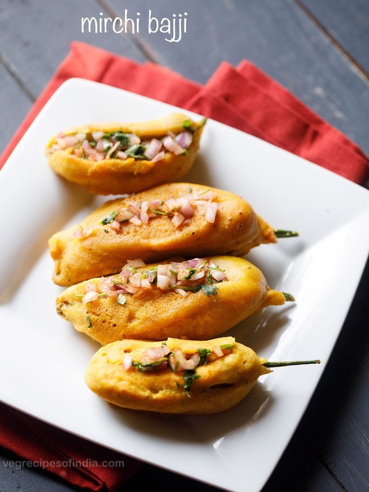 mirchi bajji served in a square white plate with text layovers. 