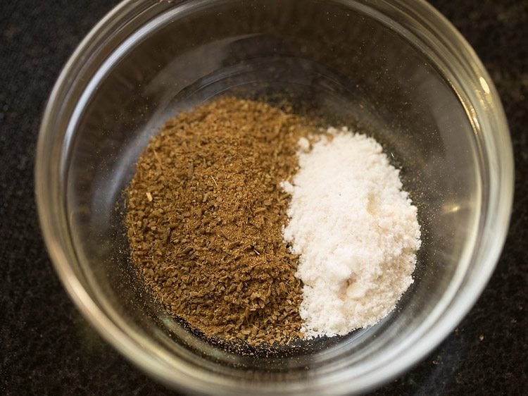 cumin powder and salt added to a glass bowl. 