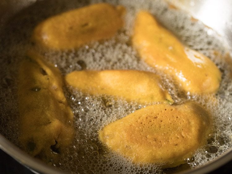 frying stuffed green chilies till golden. 