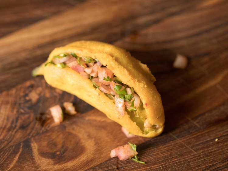 fried mirchi bajji stuffed with the prepared spiced onion-coriander leaves stuffing. 