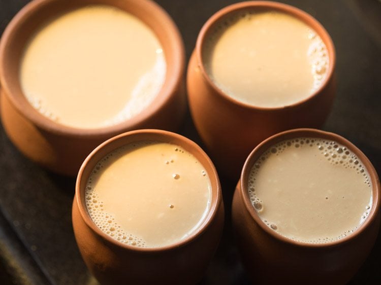 curd mixture poured in earthen bowl and handi. 