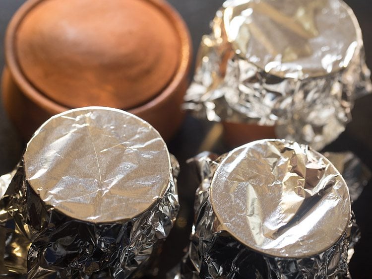 handi covered with a lid and bowls covered with aluminium foil. 