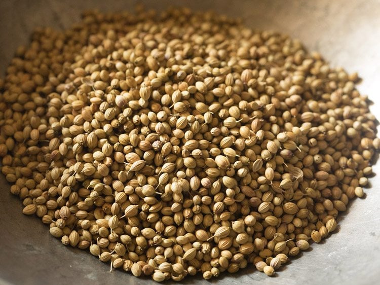 coriander seeds added in a pan. 