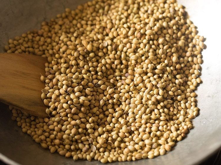 roasting coriander seeds in the pan. 