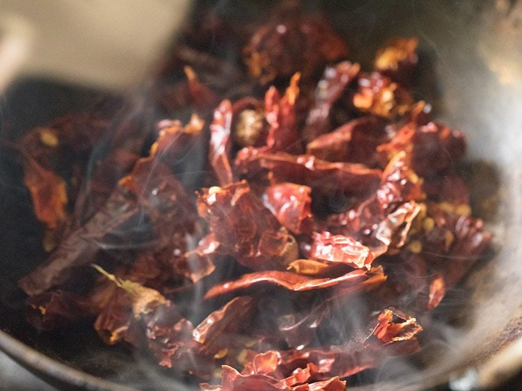 dried red chilies added to the pan. 