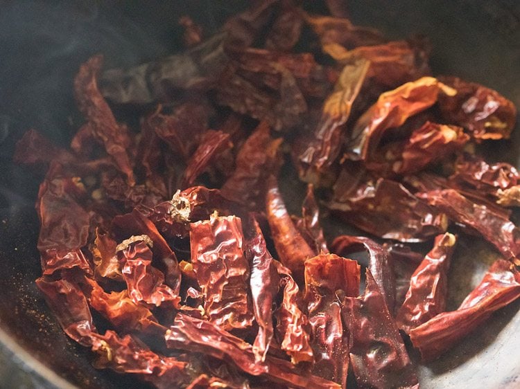 roasting dry red chillies for making rasam powder