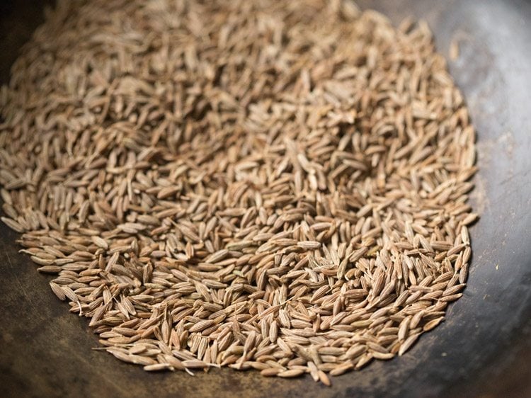 cumin seeds added to the pan. 