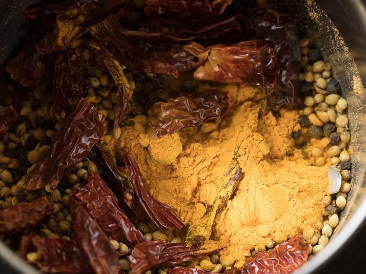 roasted spices, lentils and turmeric powder added to grinder jar. 