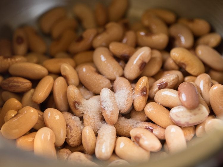 drained kidney beans and salt added to pressure cooker for refried beans recipe. 