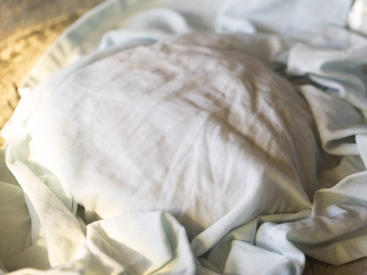 rumali roti dough covered with a moist cotton napkin. 