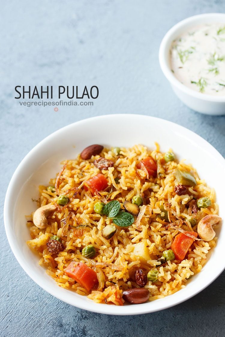 shahi pulao garnished with mint leaves, fried nuts, dry fruits, onions and served in a white bowl with a small bowl of raita kept on the top right side and text layovers.