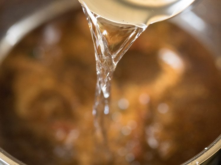 adding water to the pan. 