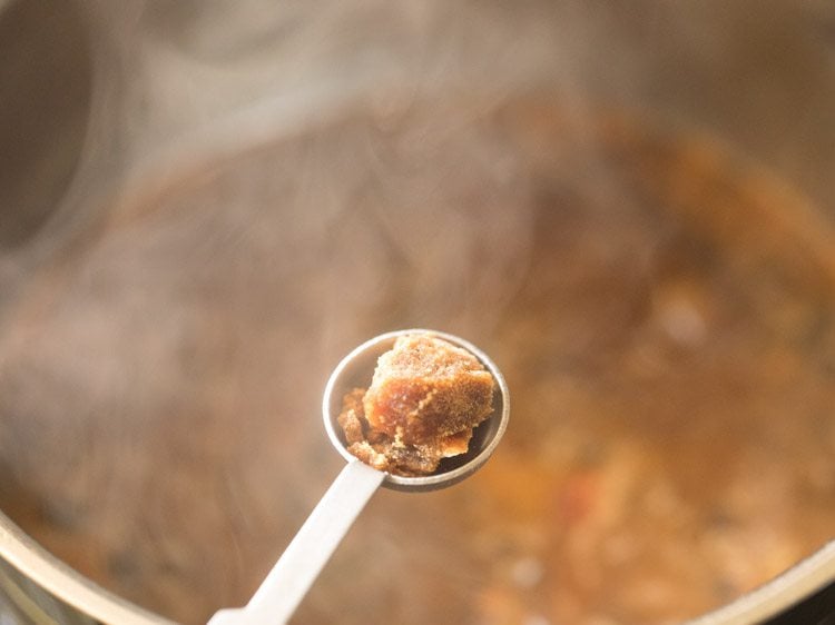 adding jaggery to the gravy. 