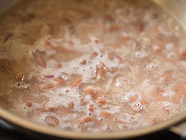 cooked kidney beans simmering in water for making Mexican refried beans. 