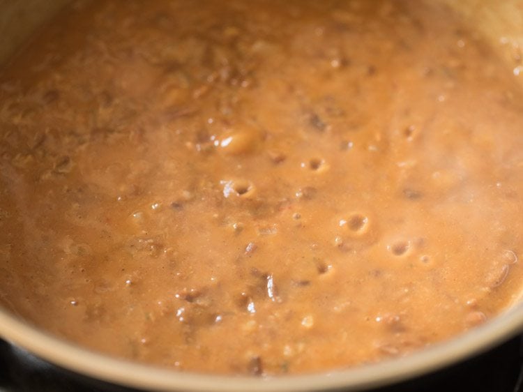 simmering refried bean mixture to thicken it. 