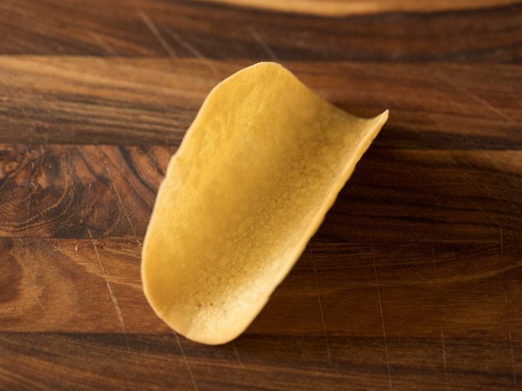 empty taco shell on a wooden cutting board. 