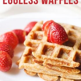 eggless waffles in a white plate with strawberries.