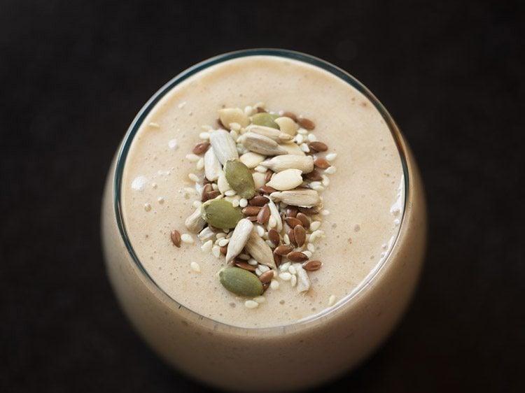 smoothie topped with nuts and seeds
