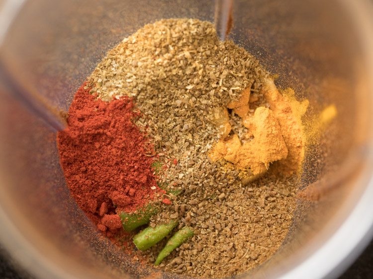 turmeric powder, red chili powder, cumin powder and coriander powder added to the grinder jar. 