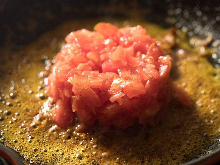 finely chopped tomatoes added to the masala paste mixture. 