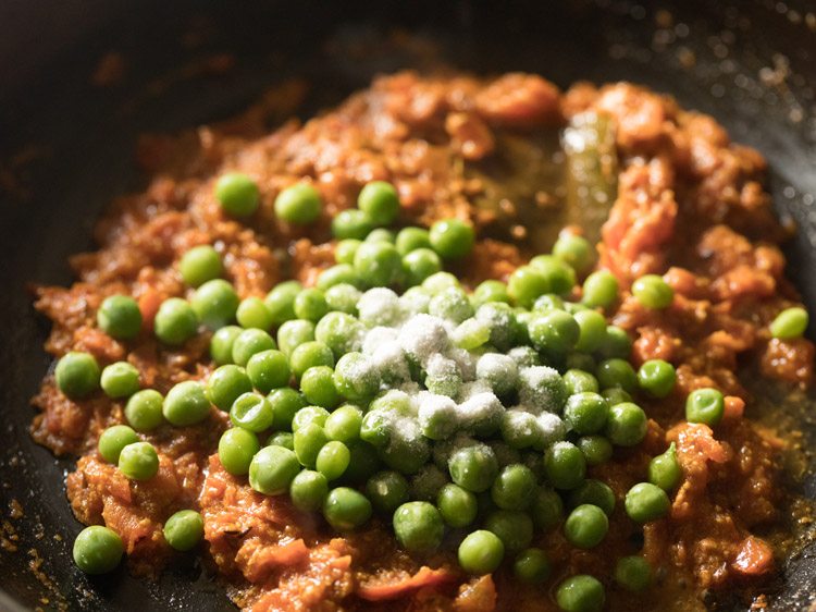 green peas and salt added to the tomato mixture. 