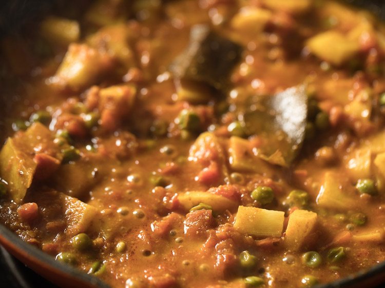 simmering curry till potatoes are cooked. 