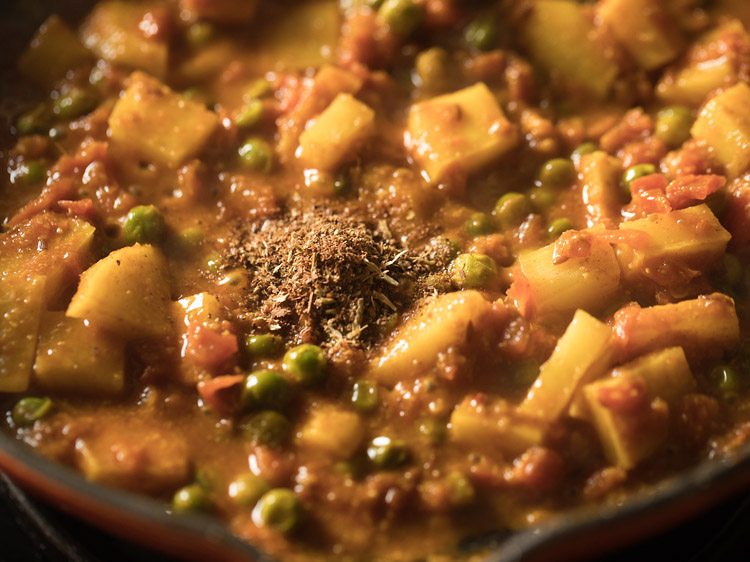 prepared bengali garam masala added to the curry. 