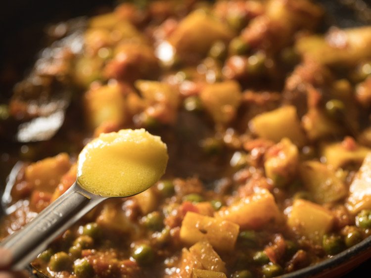 adding ghee to the curry. 